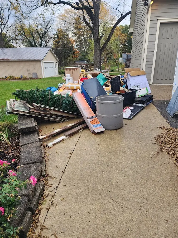 Dumpster being loaded with debris for 10 Yard Dumpster Rental in Merced